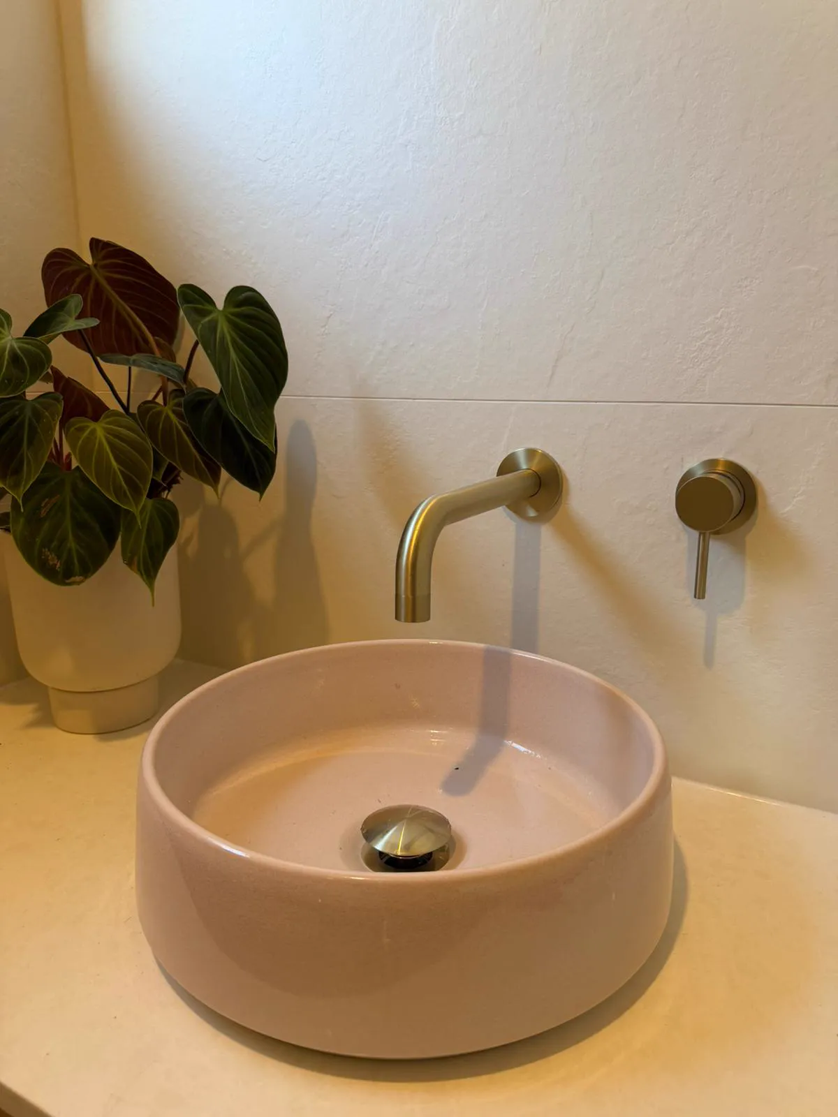 Pink ceramic vessel basin with brushed brass wall mixer, bathroom renovation Northern Beaches
