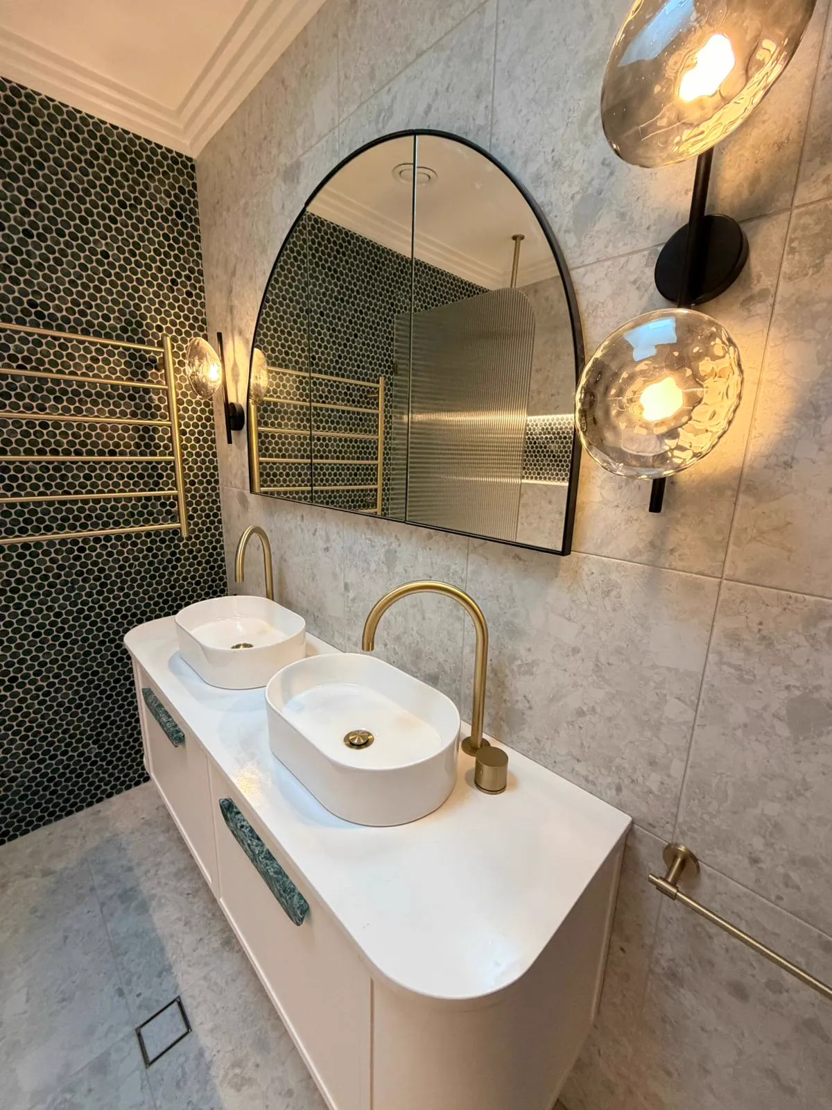 Double vanity with arched mirrors and green mosaic feature wall, bathroom renovation Northern Beaches