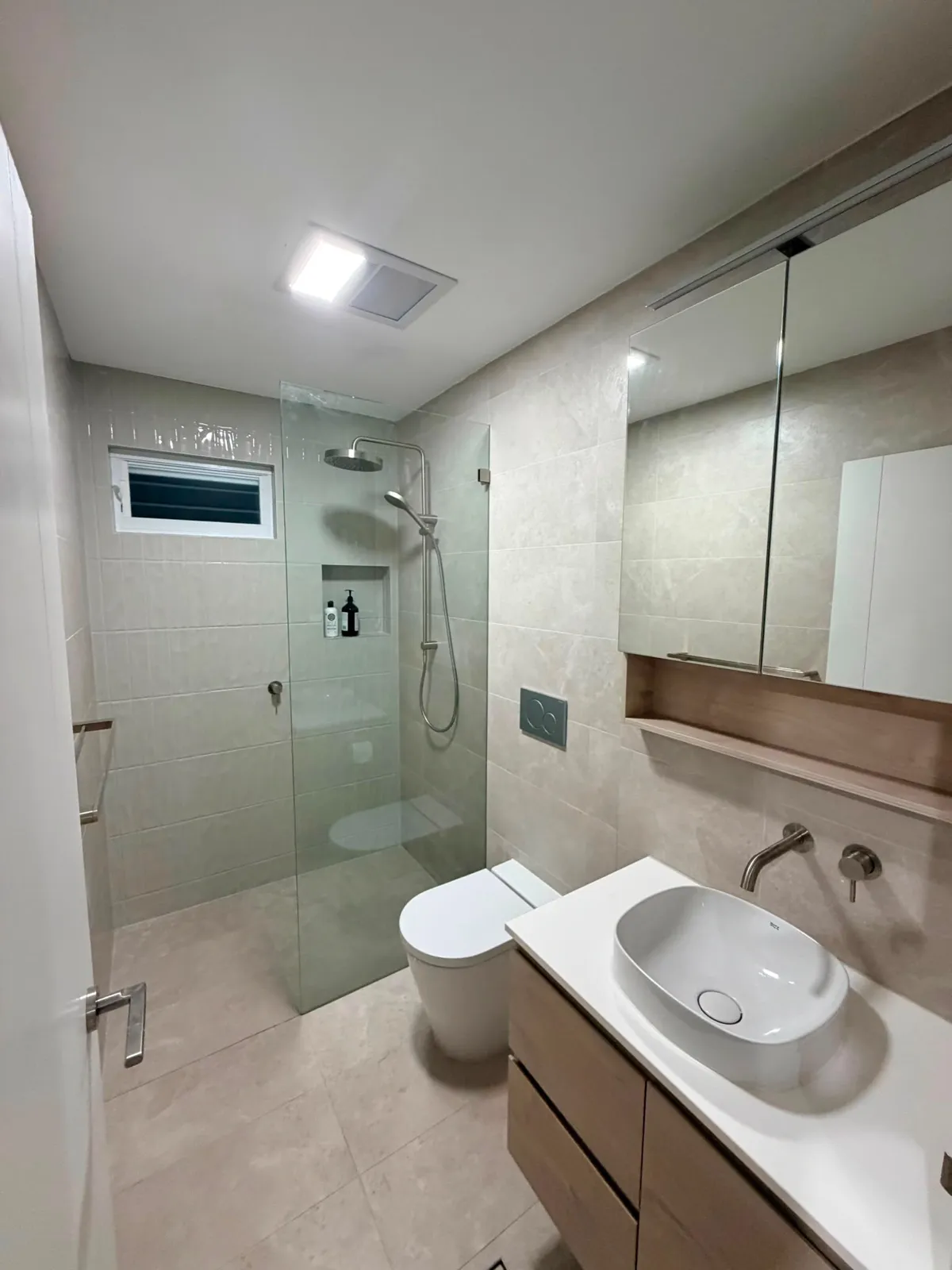 Neutral ensuite with frameless walk-in shower and timber vanity, renovation Northern Beaches