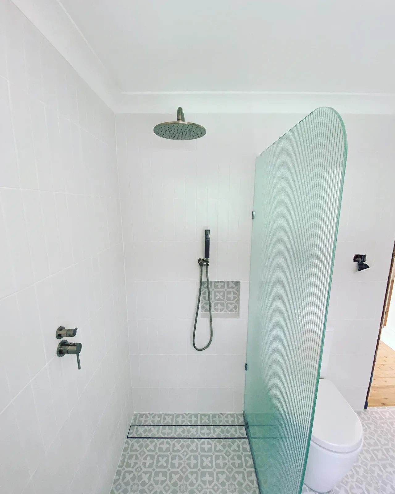 Walk-in shower with fluted glass screen, bathroom renovation