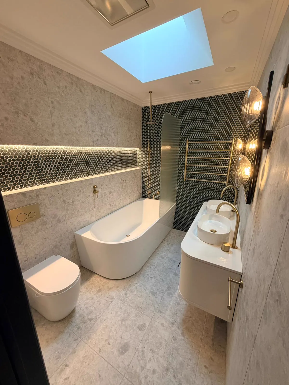 Renovated bathroom with green mosaic tiles and brass tapware, Northern Beaches